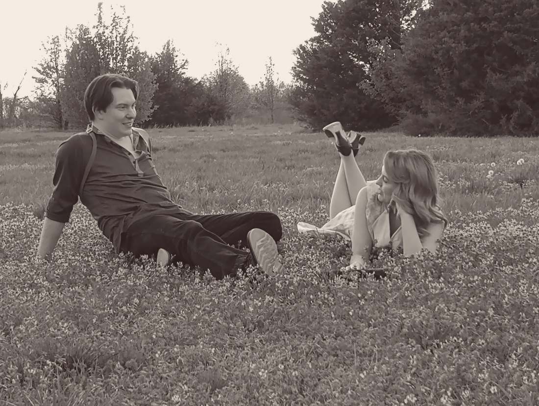 Bonnie and Clyde lounging together in a field of clover (sepia)