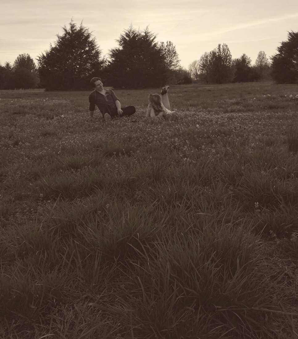 Bonnie and Clyde in a wide field of wildflowers (sepia)