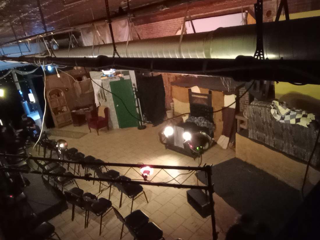 The Bonnie & Clyde stage seen from above, with the getaway car's headlights glowing