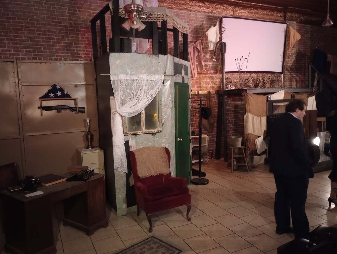 The marshal's office set, with a desk, typewriter, folded flag, and shotgun on the wall