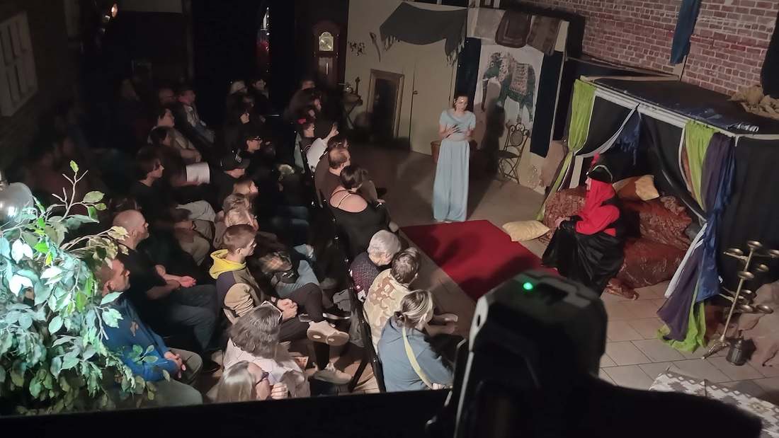 The princess faces the seated Vizier before a full house in Twisted