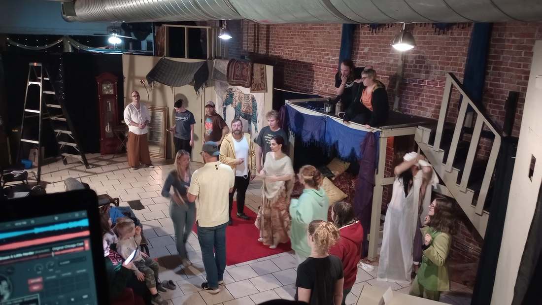 The Twisted cast gathered on the studio set during rehearsal, seen from above the booth