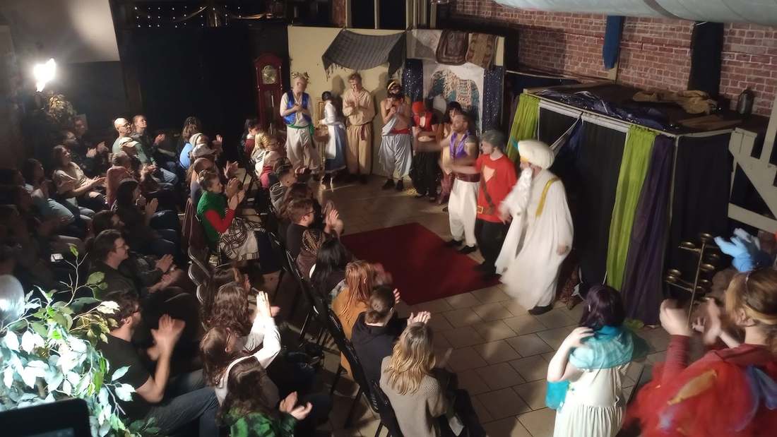 The Sultan in white robes takes his bow at the Twisted curtain call