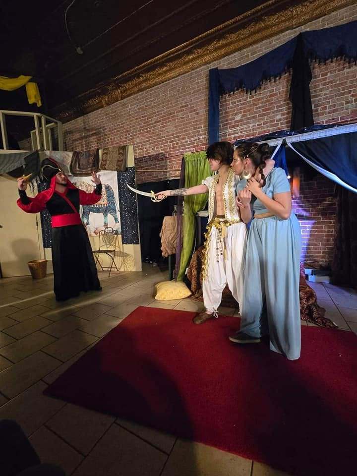 A standoff — the Vizier and the prince point each other down across the red carpet in Twisted