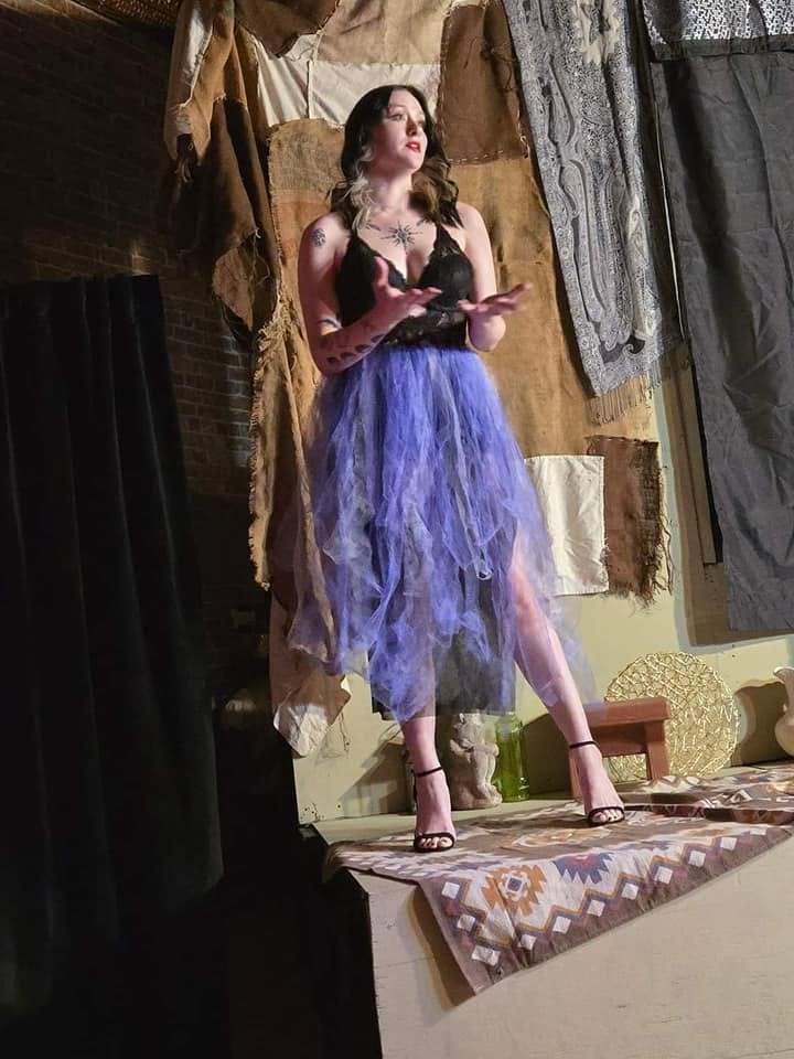 The storyteller sings from the platform in Twisted