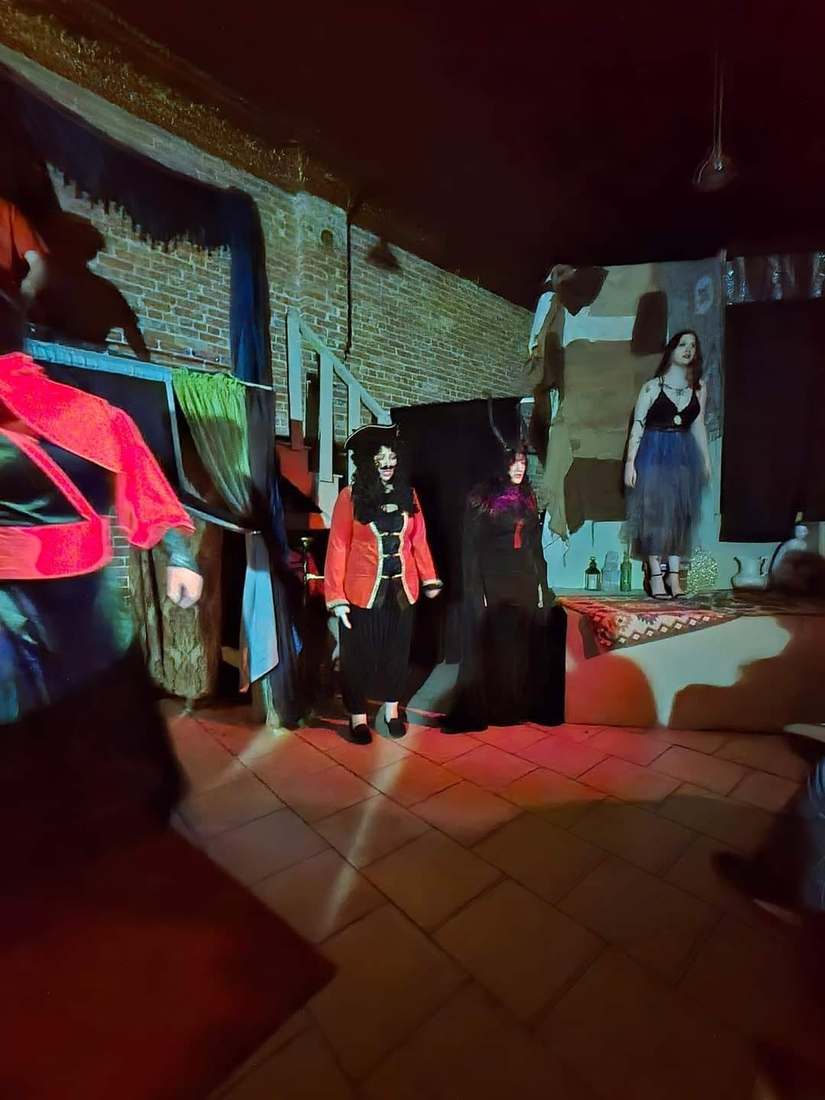 The villains assemble on the platforms under red light in Twisted